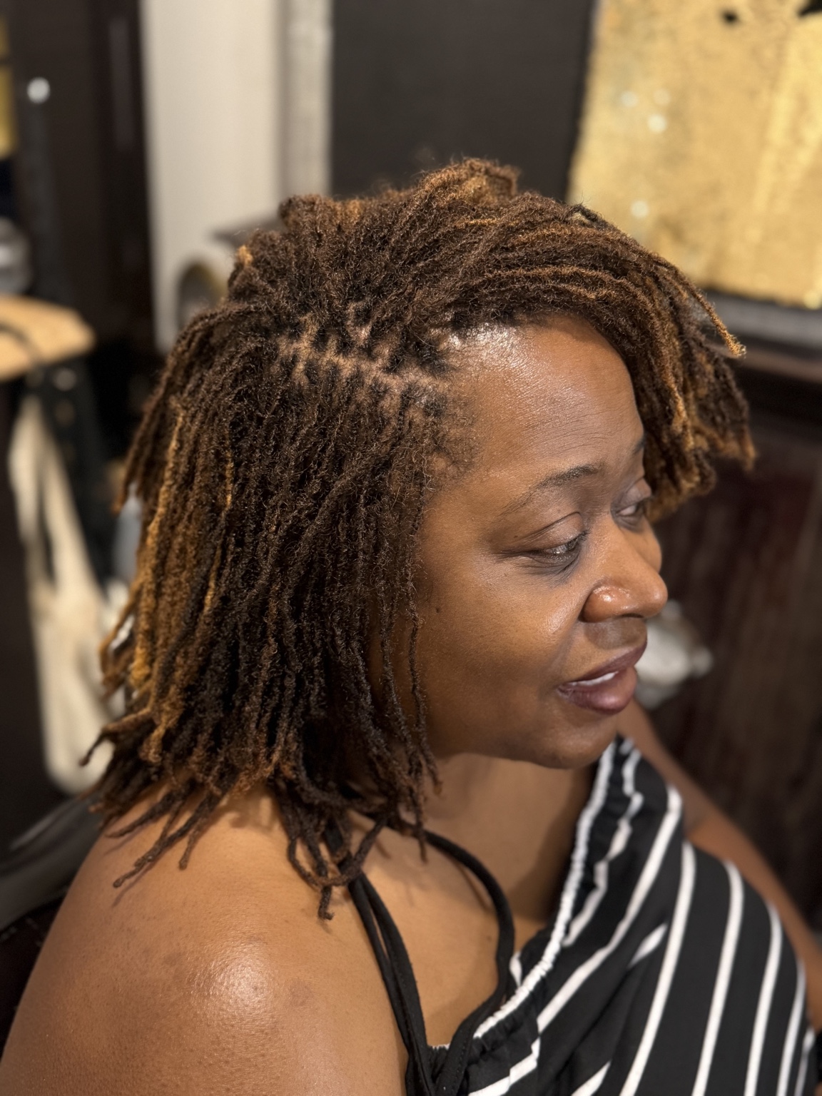 Healthy mature locs styled by Swann Stylez