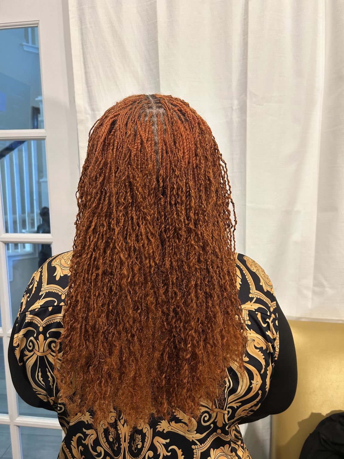 Long copper-colored locs after professional care